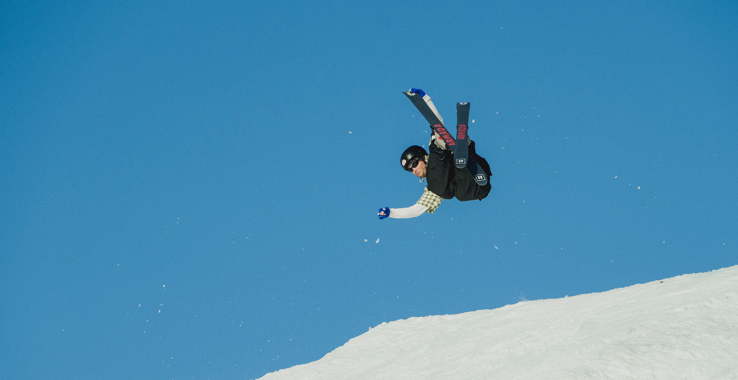 A person skiing and performing a trick.